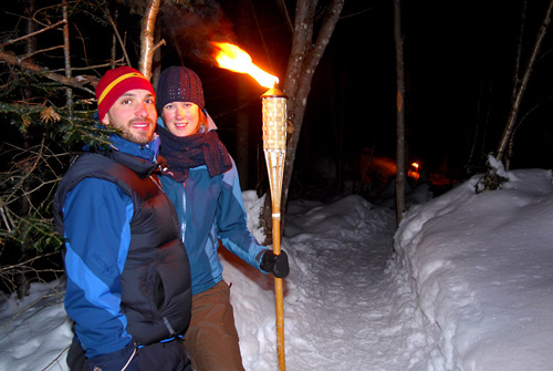Quebec Jacques Cartier Park Cross Country Skiing couple and torch 