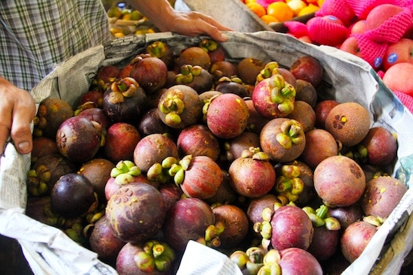 Buying Mangosteens at the Ubud Market. Photo: Leah Larkin.