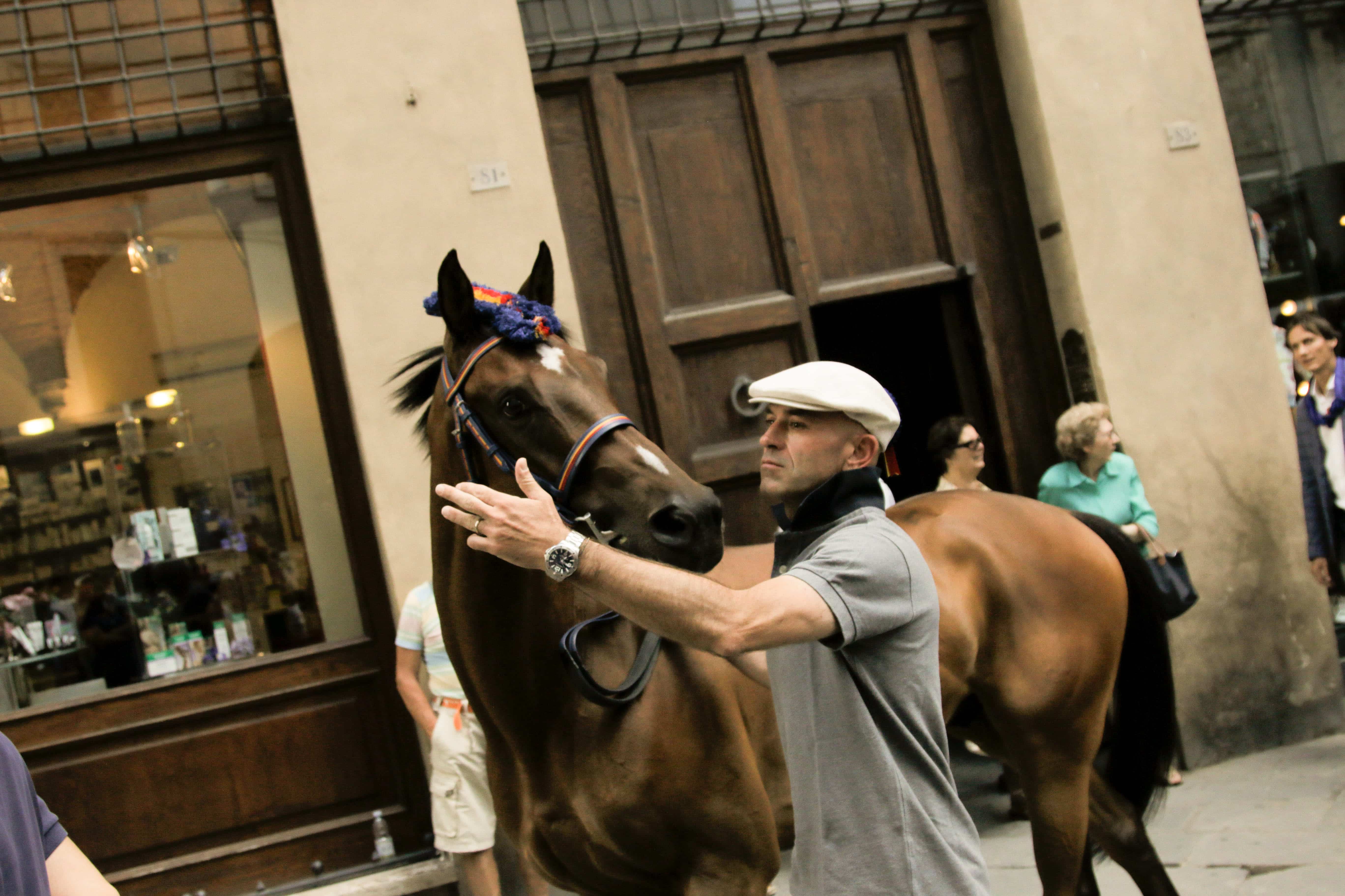 Jockeys lead their horses through the streets of Siena. Photo Credit: Jeffrey Lei