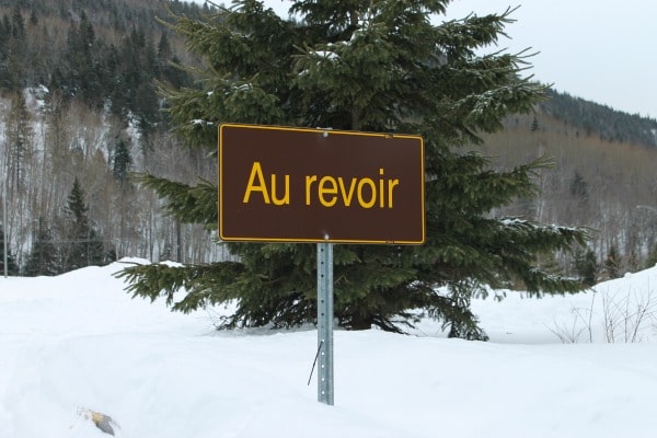 A yellow sign that is covered in snow