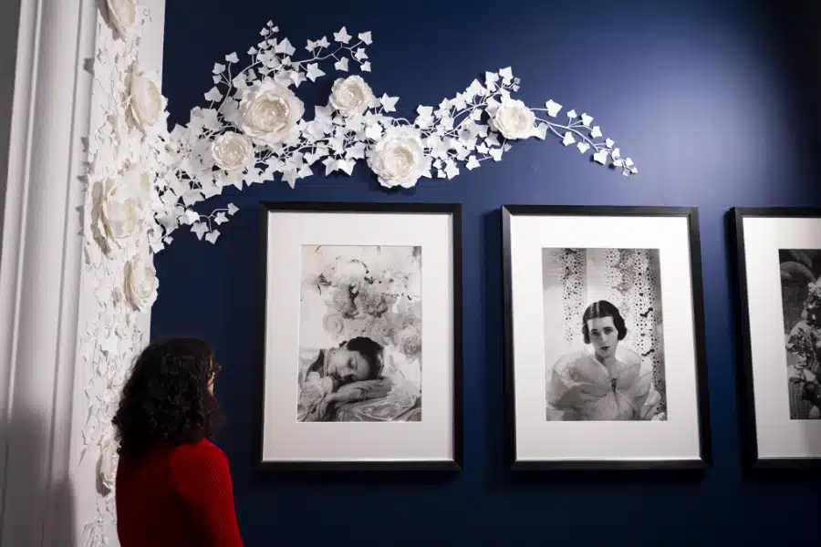 A visitor observing portraits in the Cecil Beaton's Fashionable World exhibition at the National Portrait Library.