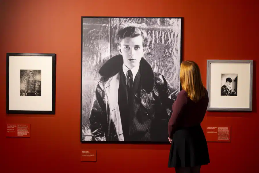 A visitor observing portraits in the Cecil Beaton's Fashionable World exhibition at the National Portrait Library.