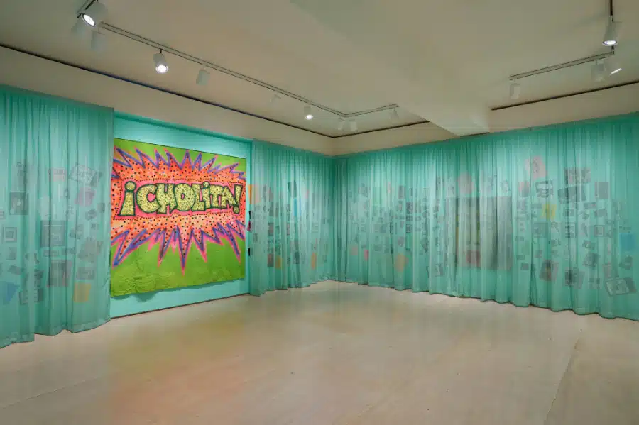 Vaginal Davis. Sucking Her Unborn Cock – Archivist Headache Wall. 1970s–present. Mixed media.The photographs on the wall have been shot by various photographers. Installation view of Vaginal Davis: Magnificent Product, on view at MoMA PS1 from October 9, 2025 through March 2, 2026.