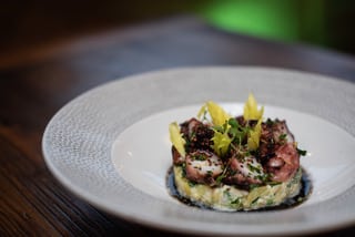 Warm Octopus with fingerling potato salad, puffed quinoa and black olive oil